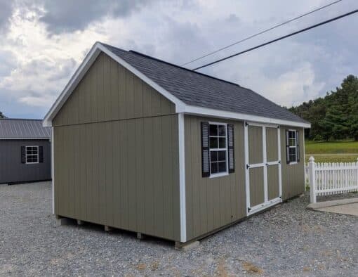 12 x 20 size painted garden style shed with clay siding, white trim, black architectural shingle roof, black shutters, (2) 8' ridge vents, ggs 6 foot double doors, two windows.