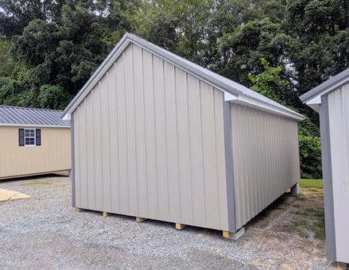 12x20 size metal garden style shed with white trim, taupe metal siding, charcoal metal roof, corners and j channel, 6 foot fiber double shed doors with two windows.