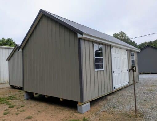 12x20 size metal garden style shed with white trim, taupe metal siding, charcoal metal roof, corners and j channel, 6 foot fiber double shed doors with two windows.