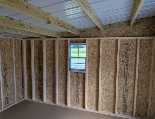 12x12 size painted economy style shed with avocado siding, white trim, alamo metal roof, white shutters, ggs 6 foot doors with two windows.