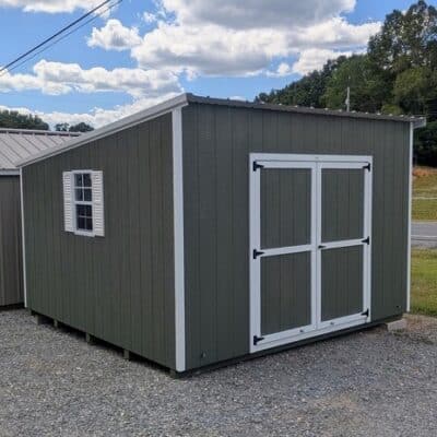 12x12 size painted economy style shed with avocado siding, white trim, alamo metal roof, white shutters, ggs 6 foot doors with two windows.