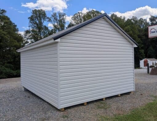 12 x 16 size vinyl classic style shed with gray siding, white trim, black metal roof, black shutters, fiber solid 6 foot double shed doors, two windows.