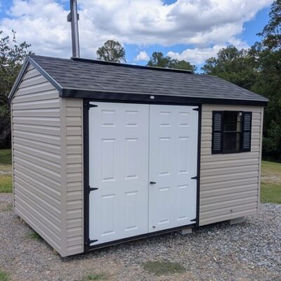 8x12 size vinyl a-roof style shed with clay siding, black trim, black architectural shingle roof, black shutters. Has 8' ridge vent, 6 foot fiber double doors and one black window.
