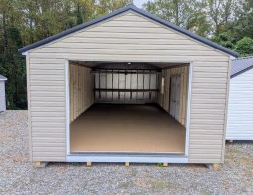 14 x 28 size vinyl a-roof garage style shed with clay siding, white trim, black metal roof, black shutters, 9x7 garage door, 6 foot fiber double doors with two windows.