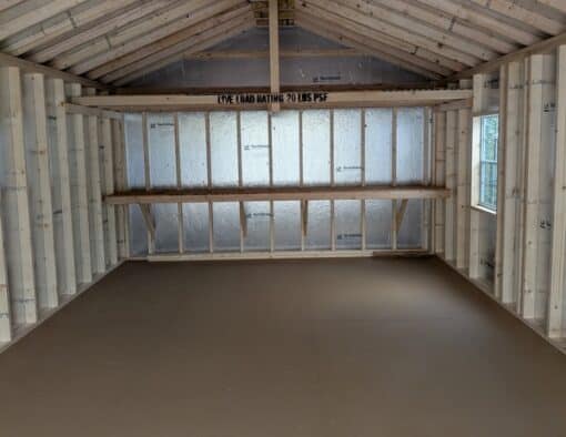 14 x 28 size vinyl a-roof garage style shed with clay siding, white trim, black metal roof, black shutters, 9x7 garage door, 6 foot fiber double doors with two windows.