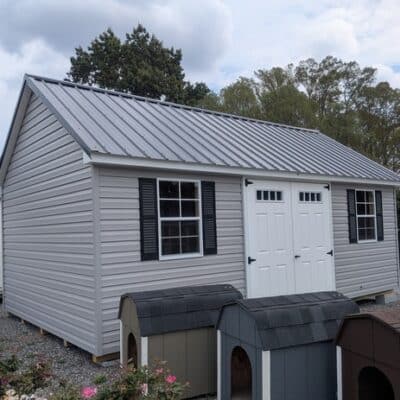 12 x 20 size vinyl garden style shed with flint siding, white trim, black metal roof, black shutters, fiber transom 6 foot double shed doors, two windows.