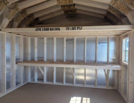 12x16 size vinyl high barn roof style shed with flint siding, white trim, estate gray architectural shingle roof, black shutters. has 8' ridge vent, 6 foot fiber double doors and two windows.