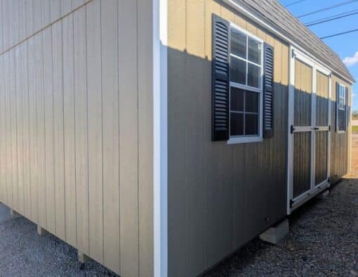 12 x 20 size painted high barn style shed with clay siding, white trim, black architectural shingle roof, black shutters, (2) 8' ridge vents, ggs 6 foot double doors, two windows.