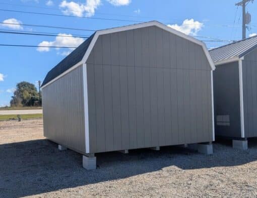 12 x 20 size painted high barn style shed with clay siding, white trim, black architectural shingle roof, black shutters, (2) 8' ridge vents, ggs 6 foot double doors, two windows.