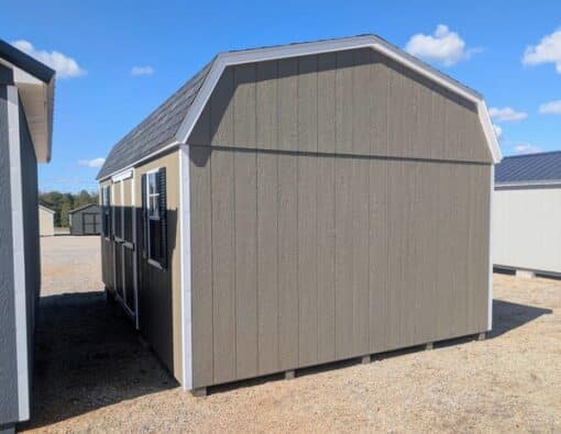 12 x 20 size painted high barn style shed with clay siding, white trim, black architectural shingle roof, black shutters, (2) 8' ridge vents, ggs 6 foot double doors, two windows.