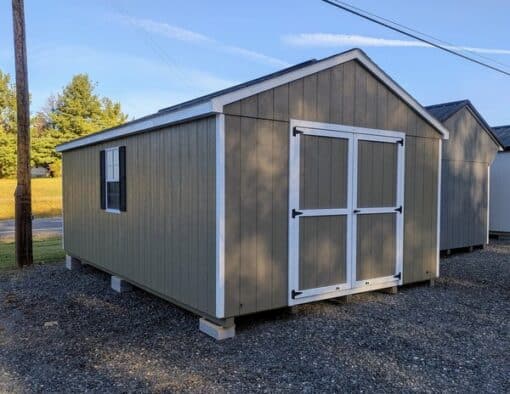 12 x 20 size painted a-roof style shed with clay siding, white trim, driftwood architectural shingle roof, black shutters, (2) 8' ridge vents, ggs 6 foot double doors, two windows.