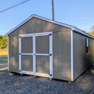 12 x 20 size painted a-roof style shed with clay siding, white trim, driftwood architectural shingle roof, black shutters, (2) 8' ridge vents, ggs 6 foot double doors, two windows.