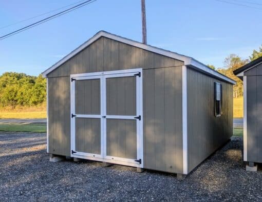 12 x 20 size painted a-roof style shed with clay siding, white trim, driftwood architectural shingle roof, black shutters, (2) 8' ridge vents, ggs 6 foot double doors, two windows.