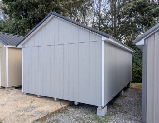 12 x 20 size painted classic style shed with gap gray siding, white trim, black metal roof, black shutters, ggs 6 foot doors, two windows.