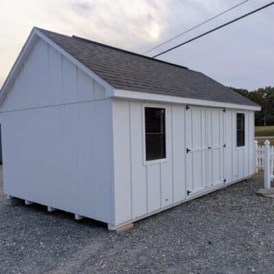 12 x 20 size painted garden board & batten style shed with white board & batten siding, white trim, black architectural shingle roof, (2) 8' ridge vents, ggs 6 foot double doors, two windows.