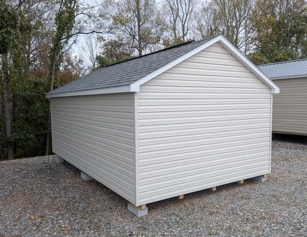 12x20 size vinyl classic roof style shed with mist siding, white trim, estate gray architectural shingle roof, black shutters. has (2) 8' ridge vents, 6 foot fiber double doors and two windows.