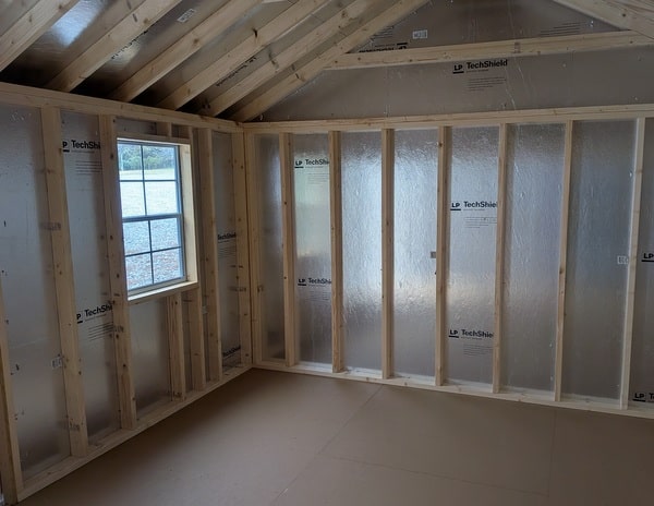 12x20 size vinyl classic roof style shed with mist siding, white trim, estate gray architectural shingle roof, black shutters. has (2) 8' ridge vents, 6 foot fiber double doors and two windows.