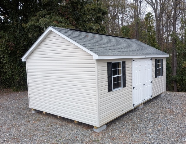 12x20 size vinyl classic roof style shed with mist siding, white trim, estate gray architectural shingle roof, black shutters. has (2) 8' ridge vents, 6 foot fiber double doors and two windows.