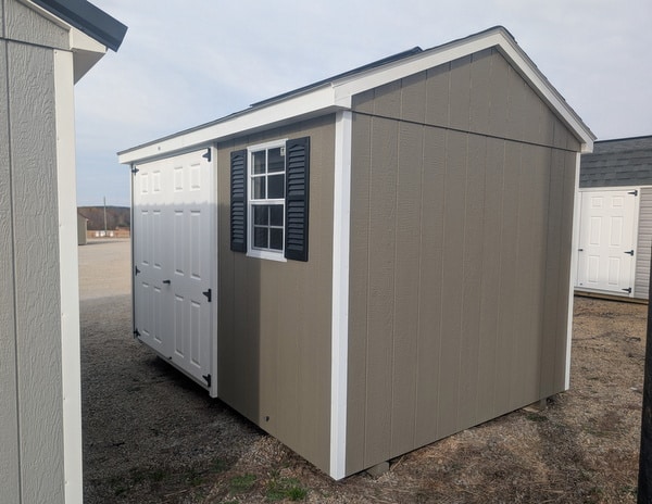 8 x 12 size painted a-roof style shed with clay siding, white trim, driftwood architectural shingle roof, black shutters, (1) 8' ridge vent, fiber solid 6 foot double doors, one window.