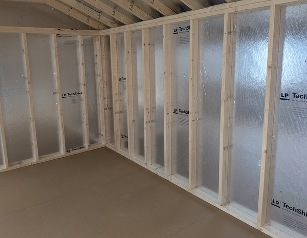 12x20 size vinyl a-roof style shed with white siding, white trim, black metal roof, black shutters. Has 6 foot fiber double doors and two windows.