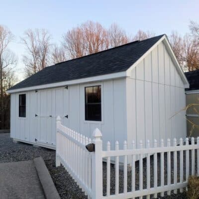 12 x 20 size painted garden board & batten style shed with white board & batten siding, white trim, black architectural shingle roof, (2) 8' ridge vents, ggs 6 foot double doors, two black windows.