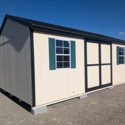 12 x 20 size painted a-roof style shed with navajo white siding, black trim, black metal roof, green shutters, ggs 6 foot doors, two windows.