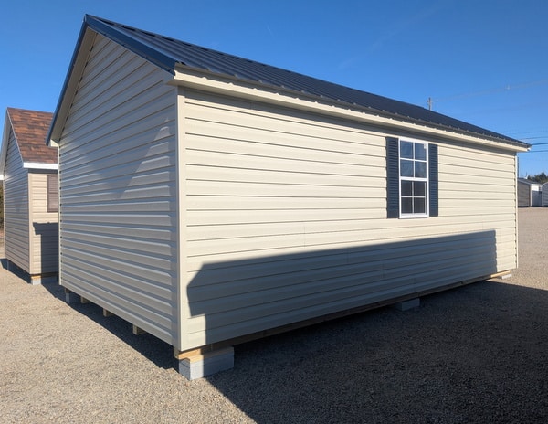12 x 20 size vinyl classic style shed with olive siding, olive trim, black metal roof, black shutters, fiber solid 6 foot double shed doors, two windows.