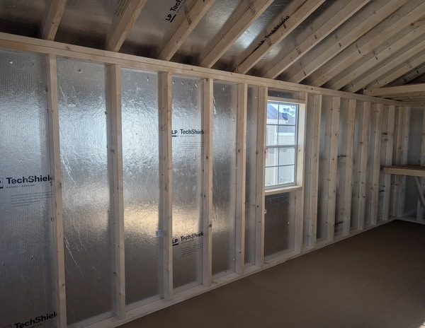 12 x 20 size vinyl classic style shed with olive siding, olive trim, black metal roof, black shutters, fiber solid 6 foot double shed doors, two windows.