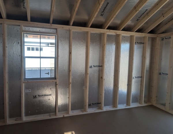 12 x 20 size vinyl classic style shed with olive siding, olive trim, black metal roof, black shutters, fiber solid 6 foot double shed doors, two windows.