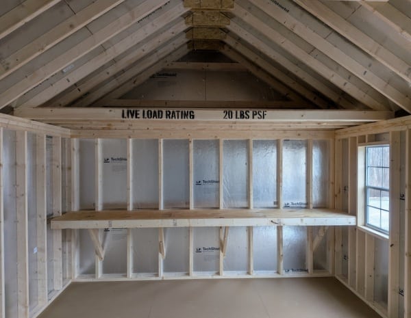 12 x 20 size vinyl garden style shed with flint siding, white trim, black metal roof, black shutters, fiber transom 6 foot double shed doors, two windows.