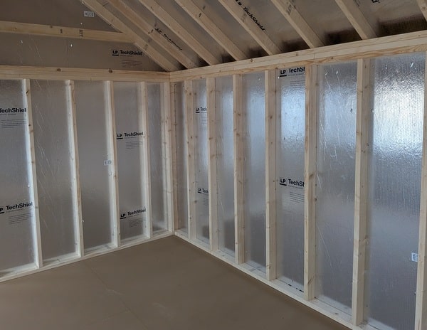 12 x 20 size vinyl garden style shed with flint siding, white trim, black metal roof, black shutters, fiber transom 6 foot double shed doors, two windows.