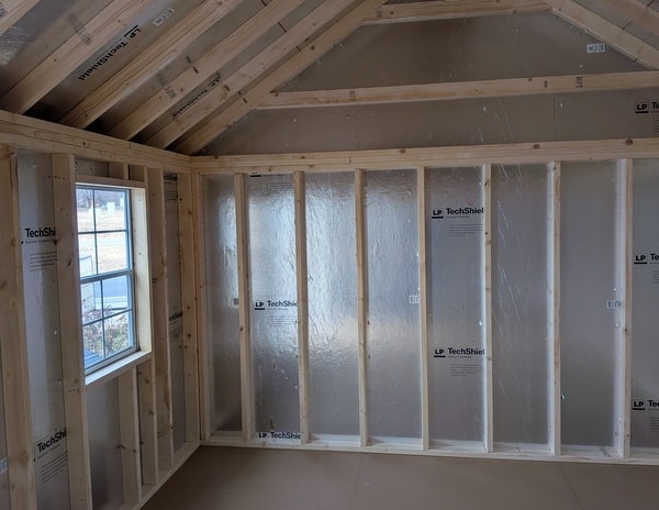 12 x 20 size vinyl garden style shed with flint siding, white trim, black metal roof, black shutters, fiber transom 6 foot double shed doors, two windows.