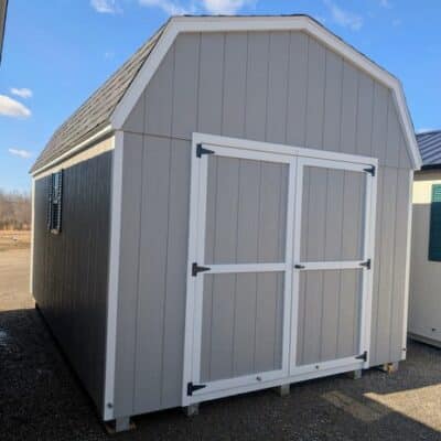 10 x 16 size painted high barn style shed with gap gray siding, white trim, black architectural shingle roof, black shutters, (1) 8' ridge vent, ggs 6 foot double doors, two windows.