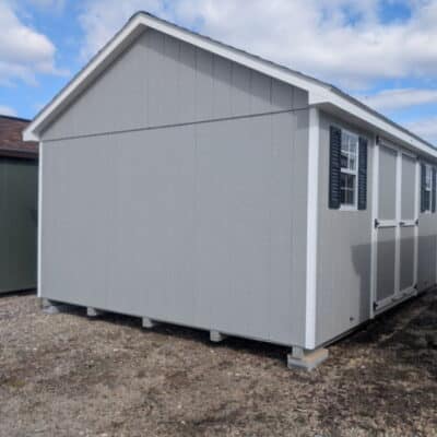 12 x 16 size painted classic style shed with gap gray siding, white trim, black architectural shingle roof, black shutters, (1) 8' ridge vent, ggs 6 foot double doors, two windows.