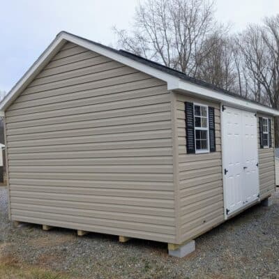 12x16 size vinyl classic roof style shed with clay siding, white trim, black architectural shingle roof, black shutters. has 8' ridge vent, 6 foot fiber double doors and two windows.