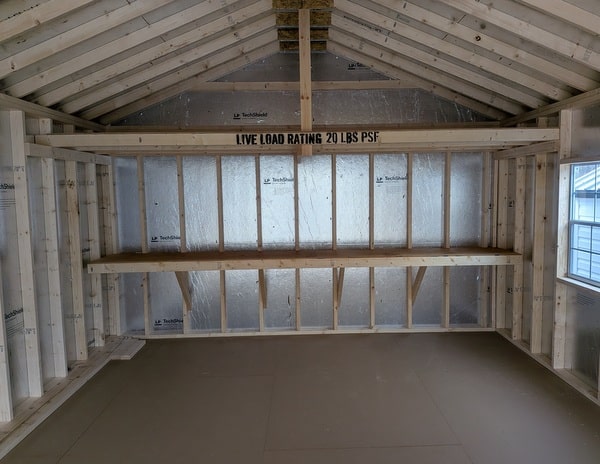 14 x 28 size vinyl a-roof garage style shed with flint siding, white trim, black metal roof, black shutters, 9x7 garage door, 6 foot fiber double doors with two windows.