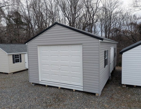 14 x 28 size vinyl a-roof garage style shed with flint siding, white trim, black metal roof, black shutters, 9x7 garage door, 6 foot fiber double doors with two windows.