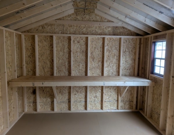 10 x 16 size painted a-roof style shed with pinnacle red siding, white trim, black metal roof, white shutters, ggs 6 foot double doors, two windows.
