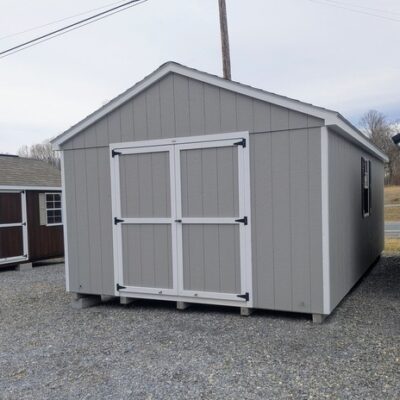12 x 20 size painted a-roof style shed with gap gray siding, white trim, black architectural shingle roof, black shutters, (2) 8' ridge vents, ggs 6 foot double doors, two windows.