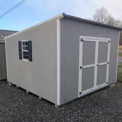 12x12 size painted economy style shed with gap gray siding, white trim, alamo metal roof, black shutters, ggs 6 foot doors with two windows.