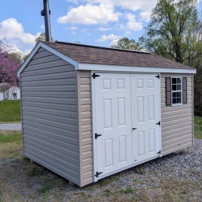8x12 size vinyl a-roof style shed with clay siding, white trim, brownwood architectural shingle roof, brown shutters. Has 8' ridge vent, 6 foot fiber double doors and one window.