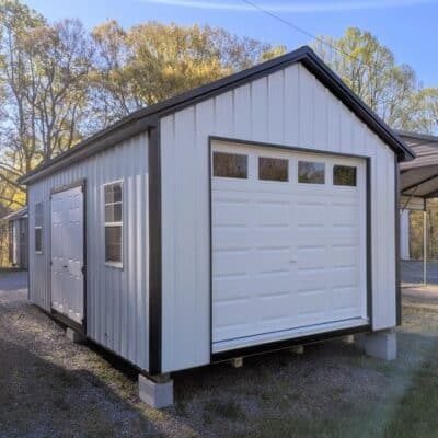 12x20 size metal classic garage style shed with black trim, alamo metal siding, black metal roof, corners and j channel, 8x7 garage door with glass, 6' foot fiber solid double shed doors with two windows.