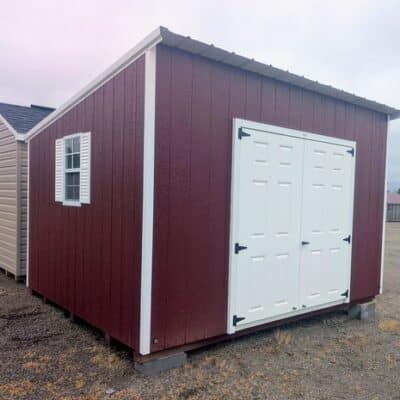 10x12 size painted economy style shed with pinnacle red siding, white trim, alamo metal roof, white shutters, fiber solid 6 foot doors with two windows.