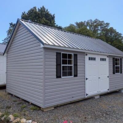 12 x 20 size vinyl garden style shed with flint siding, white trim, black metal roof, black shutters, fiber transom 6 foot double shed doors, two windows.
