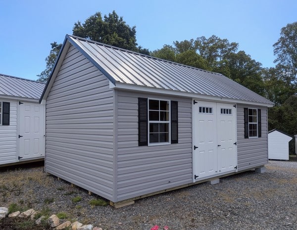 12 x 20 size vinyl garden style shed with flint siding, white trim, black metal roof, black shutters, fiber transom 6 foot double shed doors, two windows.