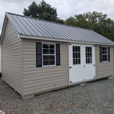 12 x 20 size vinyl garden style shed with clay siding, white trim, black metal roof, black shutters, fiber 9 lite 6 foot double shed doors, two windows.