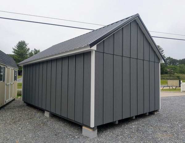 12 x 20 size painted garden board & batten style shed with gray board & batten siding, white trim, black metal roof, ggs 6 foot double doors, two windows.