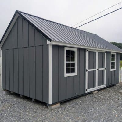 12 x 20 size painted garden board & batten style shed with gray board & batten siding, white trim, black metal roof, ggs 6 foot double doors, two windows.
