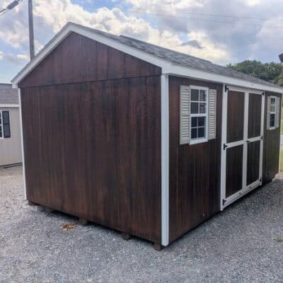 10 x 16 size painted a-roof style shed with stain mahogany siding, white trim, black architectural shingle roof, clay shutters, 10' ridge vent, ggs 6 foot double doors, two windows.