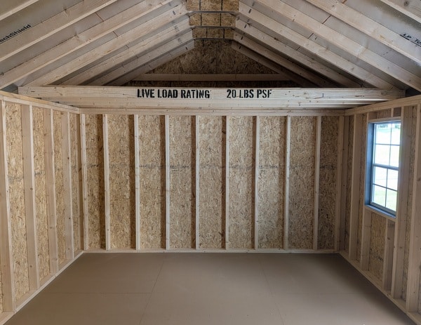 12 x 20 size painted classic style shed with gray siding, white trim, black architectural shingle roof, black shutters, (2) 10' ridge vents, ggs 6 foot double doors, two windows.